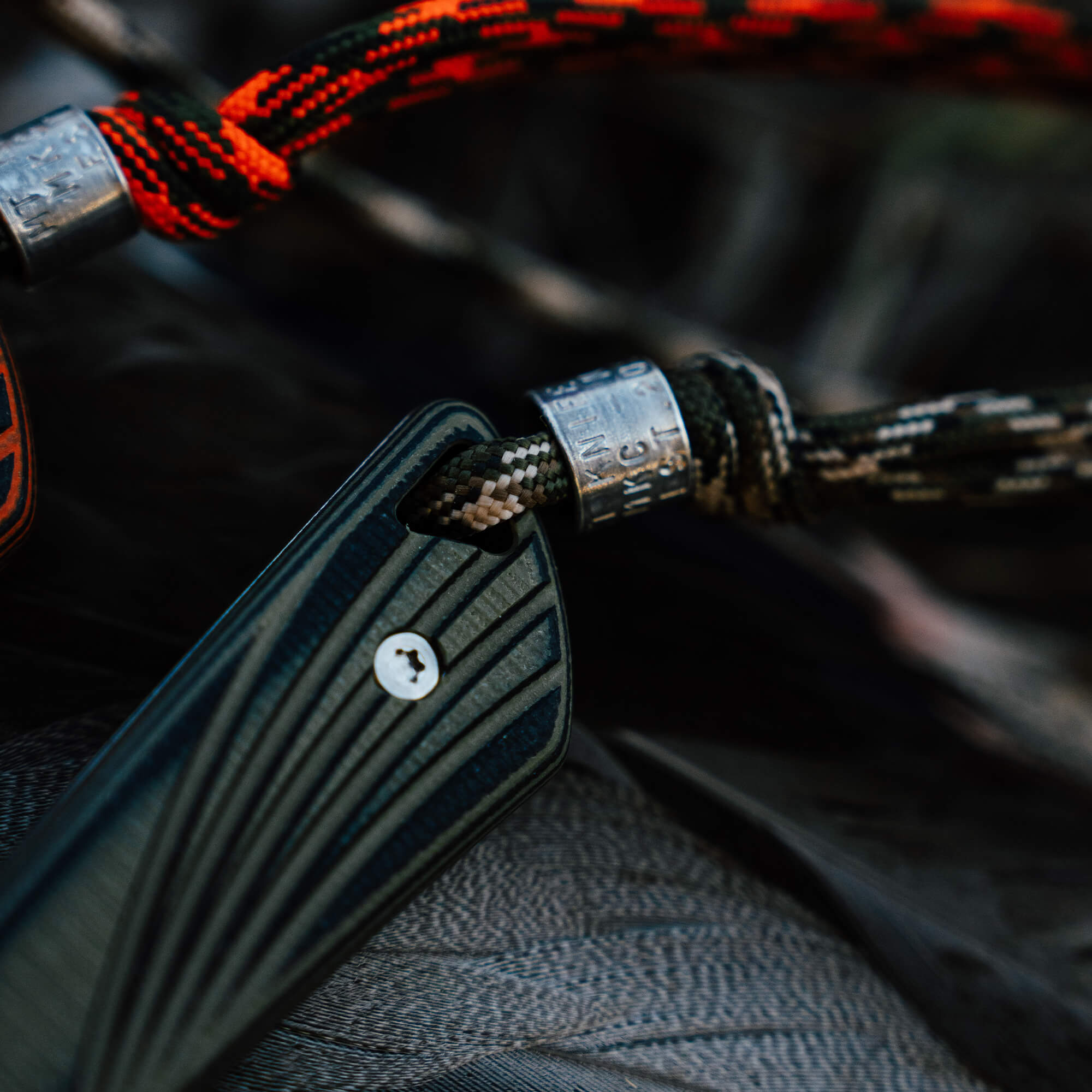 Close-up of the CHÊNE Freezout knife handle and lanyard, showcasing premium materials and craftsmanship.