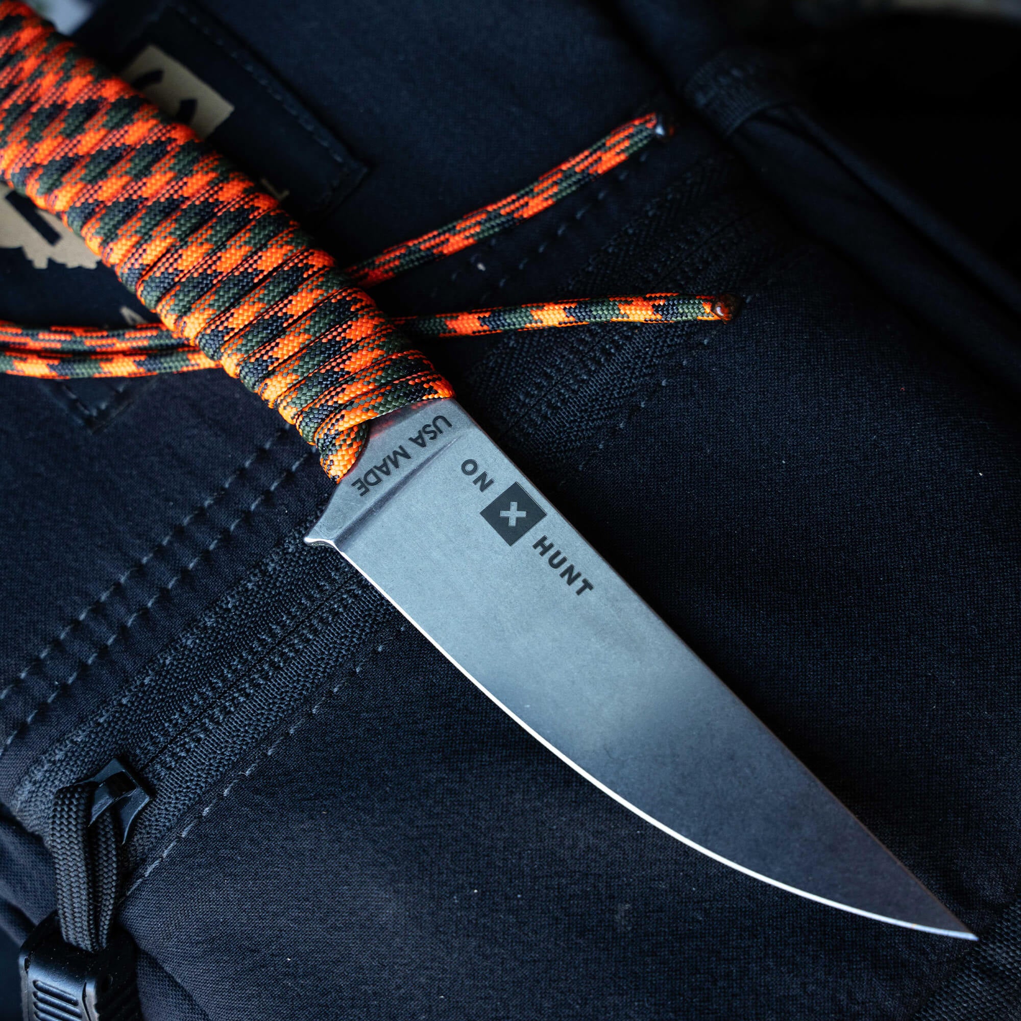 ONX Hunt Magnacut Speedgoat 2.0 knife with a textured orange and black handle, designed for outdoor enthusiasts and hunters.