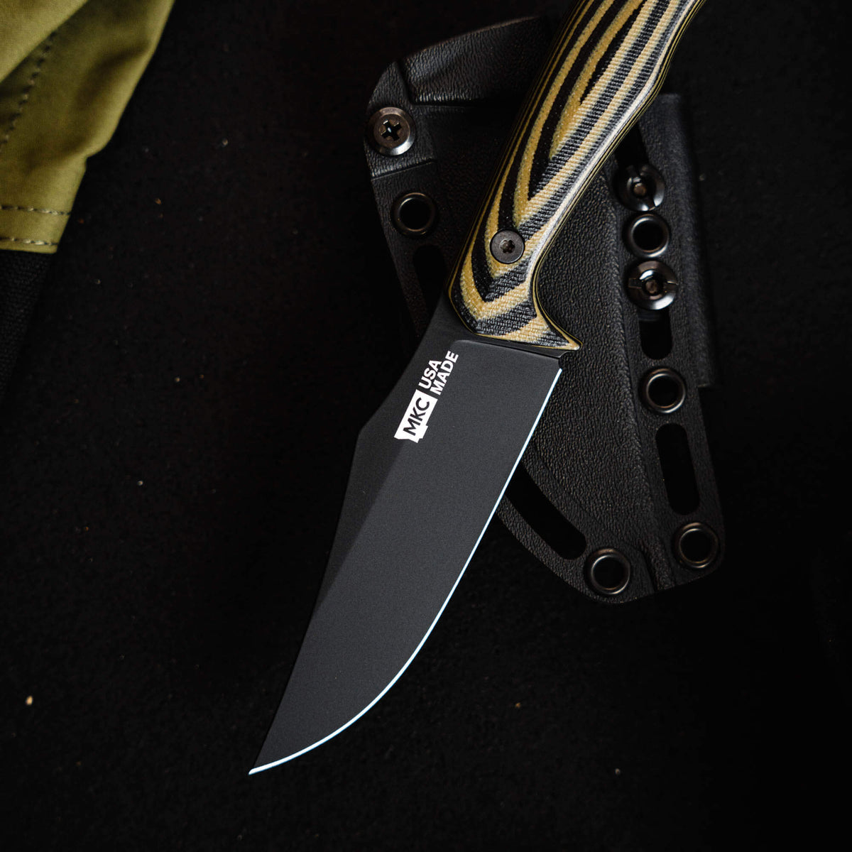 Triumph Pro knife in green and black with a sleek blade and textured handle, designed for outdoor and tactical use.