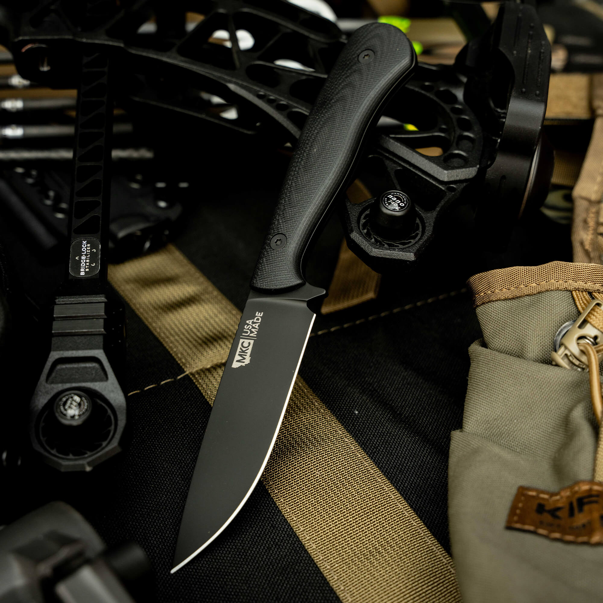 MKC Whitetail knife on a tactical background, showcasing its sleek design and durable materials for outdoor use.