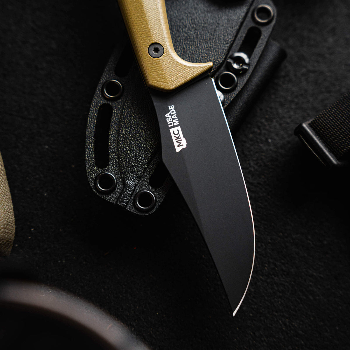 Olive green handle Triumph Pro knife with a black blade, showcasing American craftsmanship and durability.