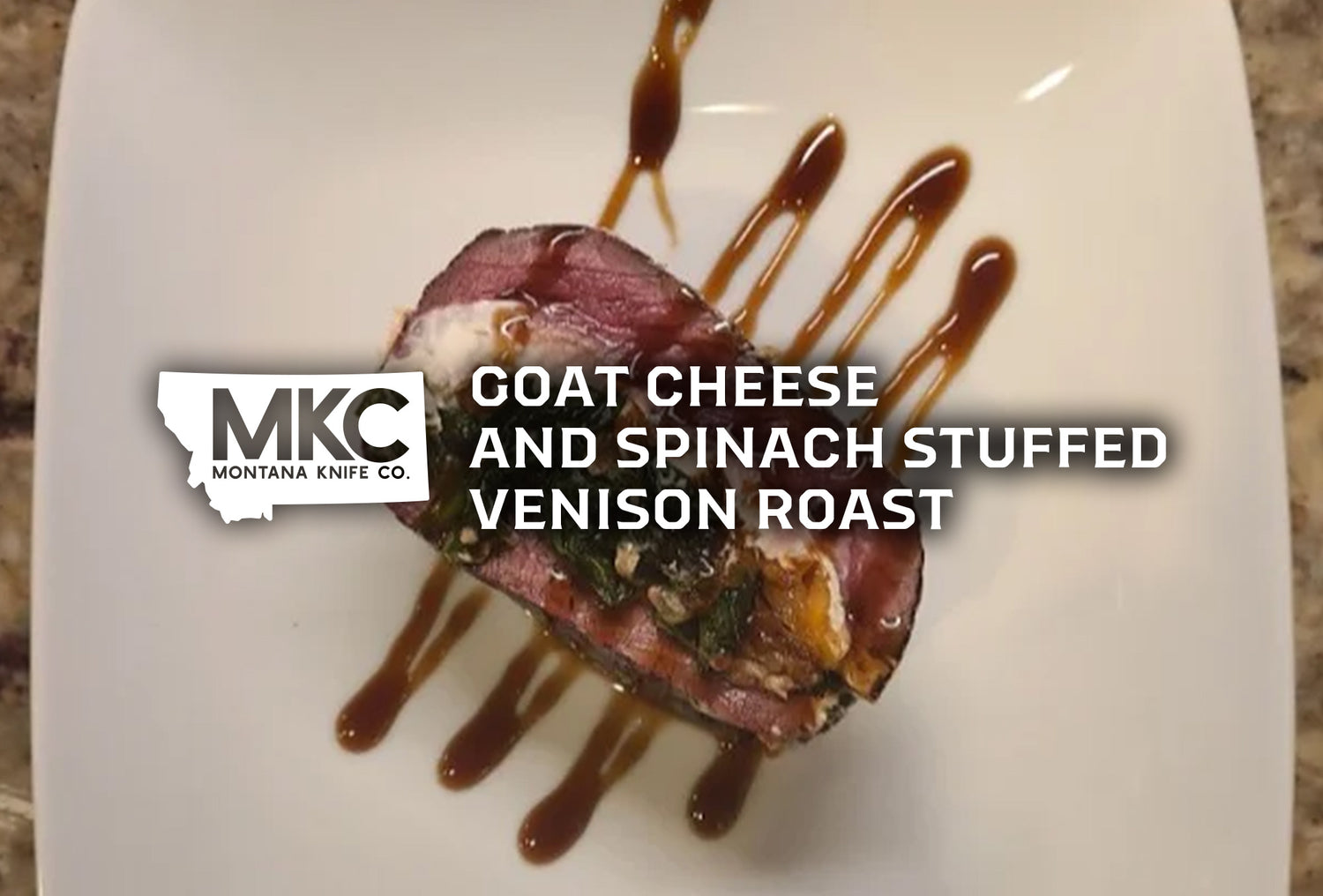 A top-down shot of a goat cheese and spinach stuffed venison roast, drizzled with a balsamic glaze.