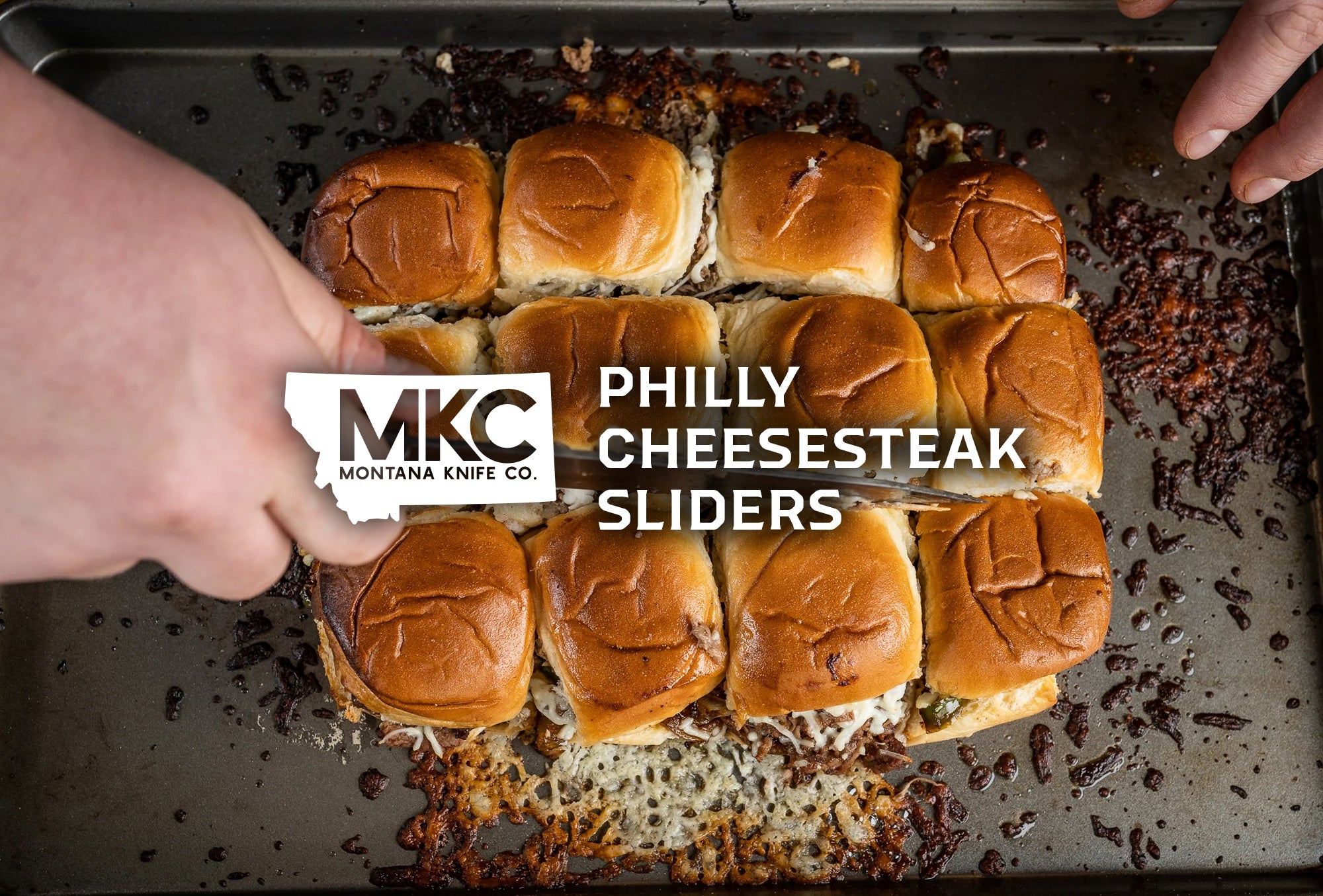 A top-down view of a dozen delicious Philly cheesesteak sliders.