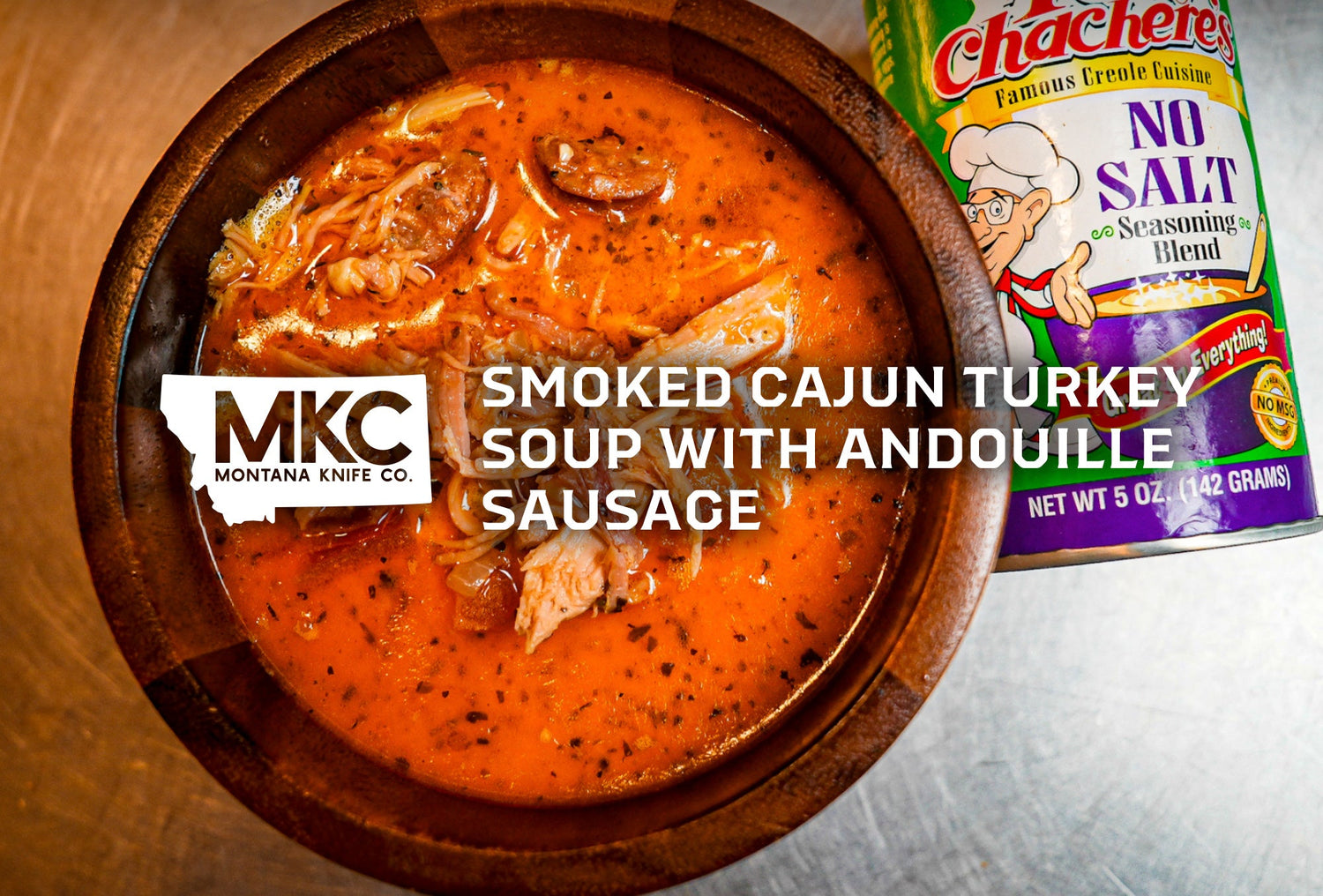 Bowl of Cajun turkey soup beside a bottle of seasoning blend.