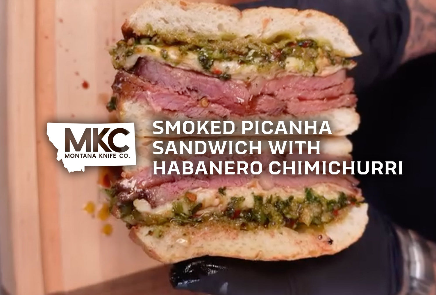 Smoked picanha chimichurri sandwich on toasted ciabatta with melted provolone cheese and fresh herbs.