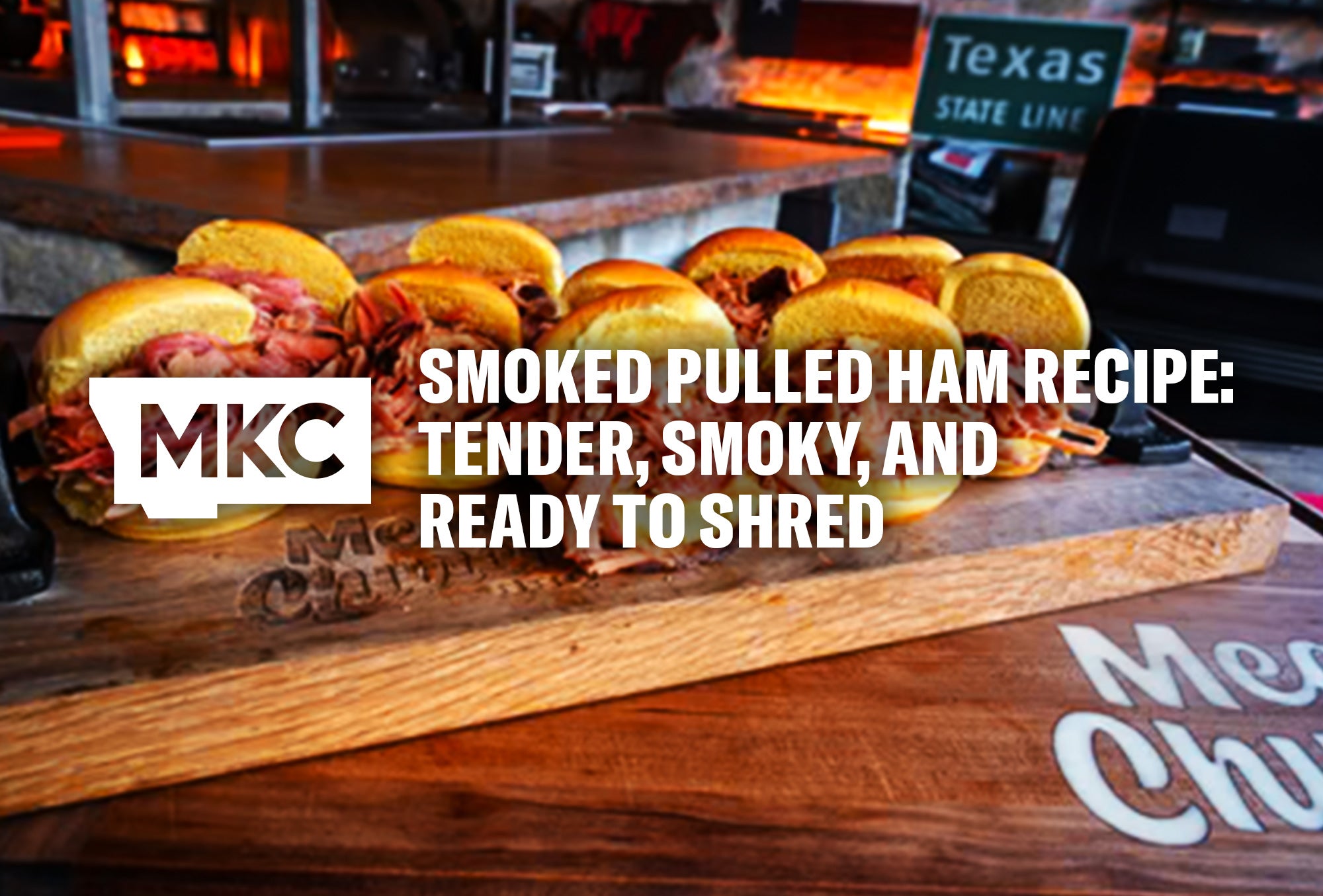 Several smoked pulled ham sandwiches arranged on a wooden cutting board for a smoked pulled ham recipe.