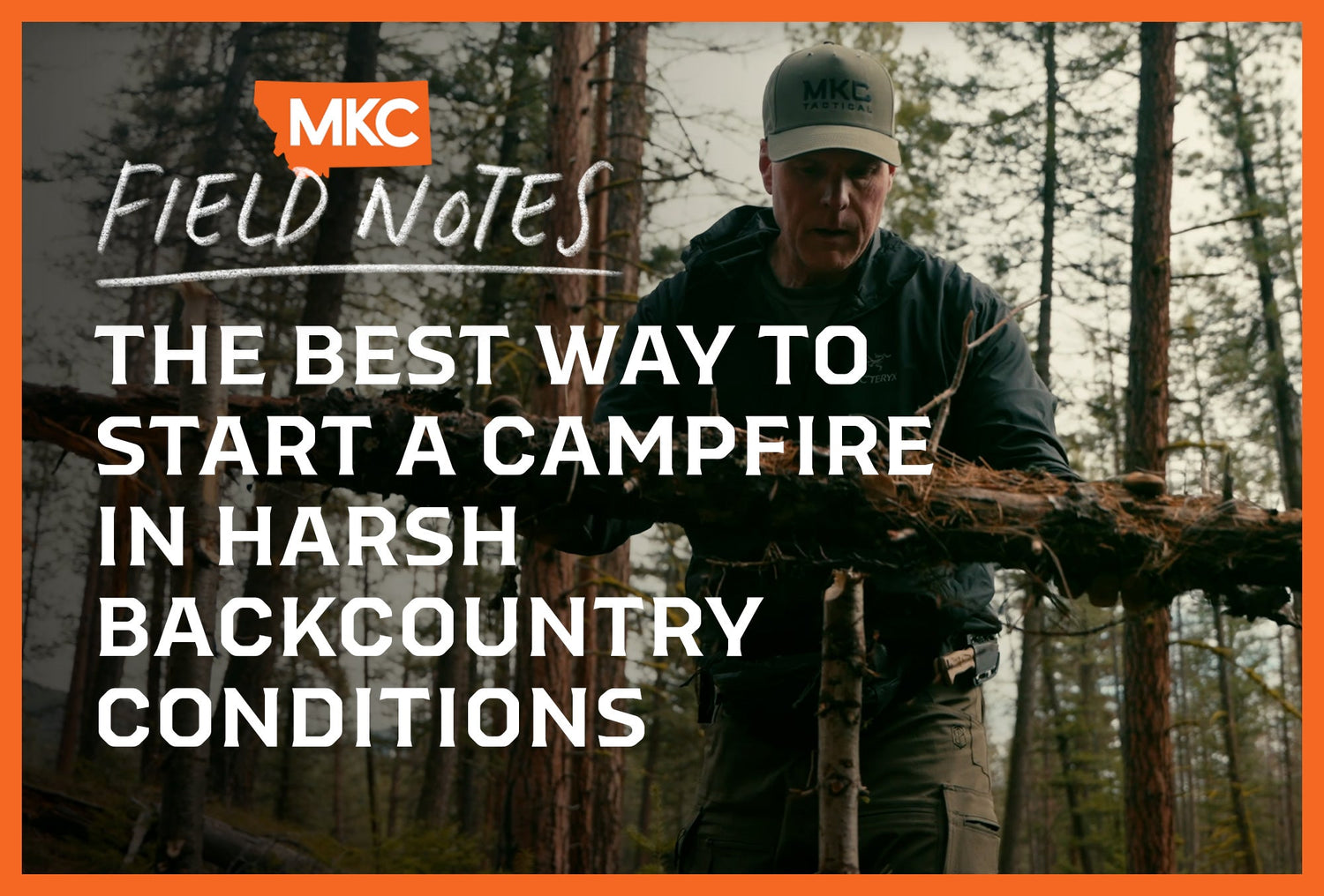 Man in an MKC hat stands in the woods preparing to build a campfire in the harsh backcountry.