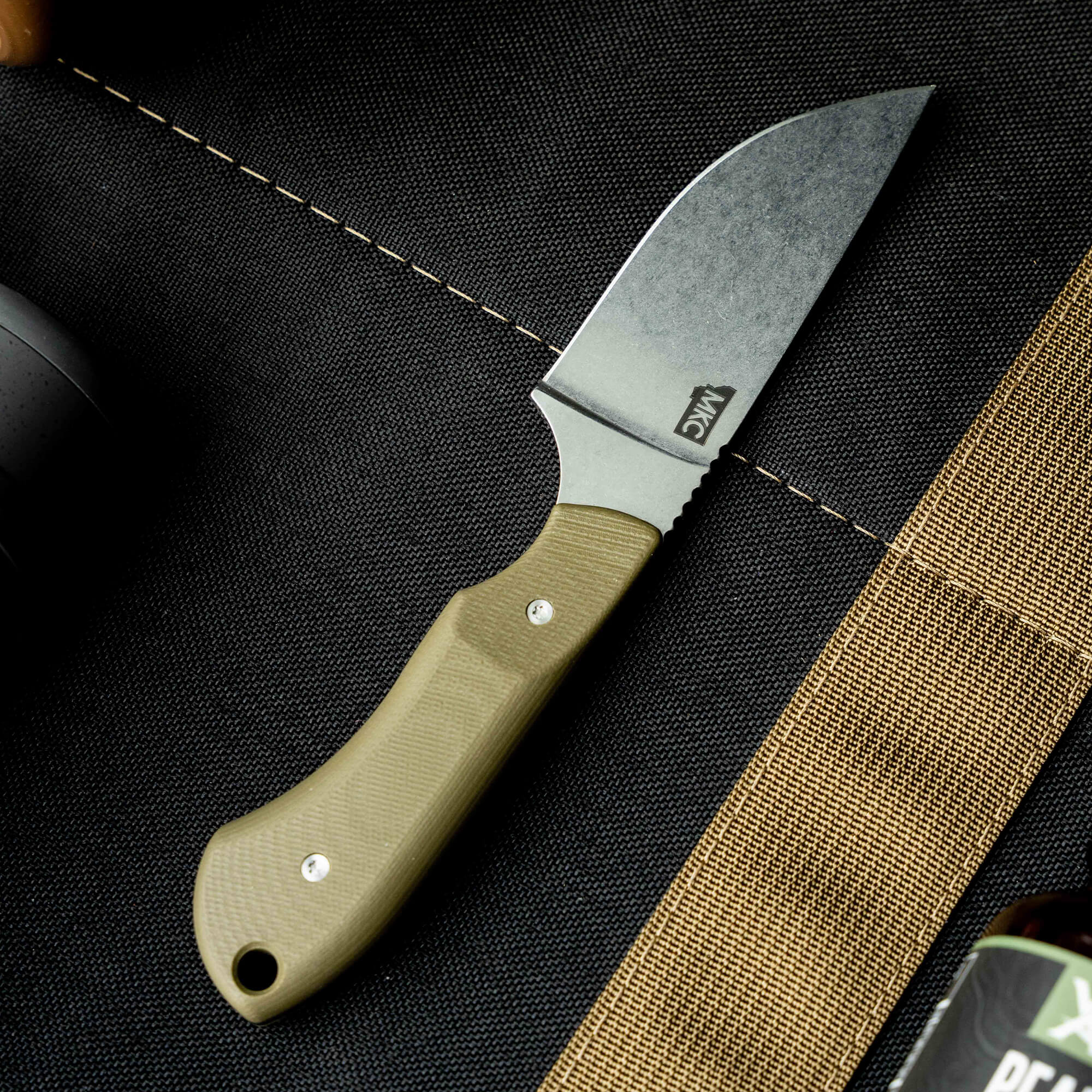 MKC Elk Knife with a durable green handle and a sleek blade, designed for outdoor enthusiasts and hunters.