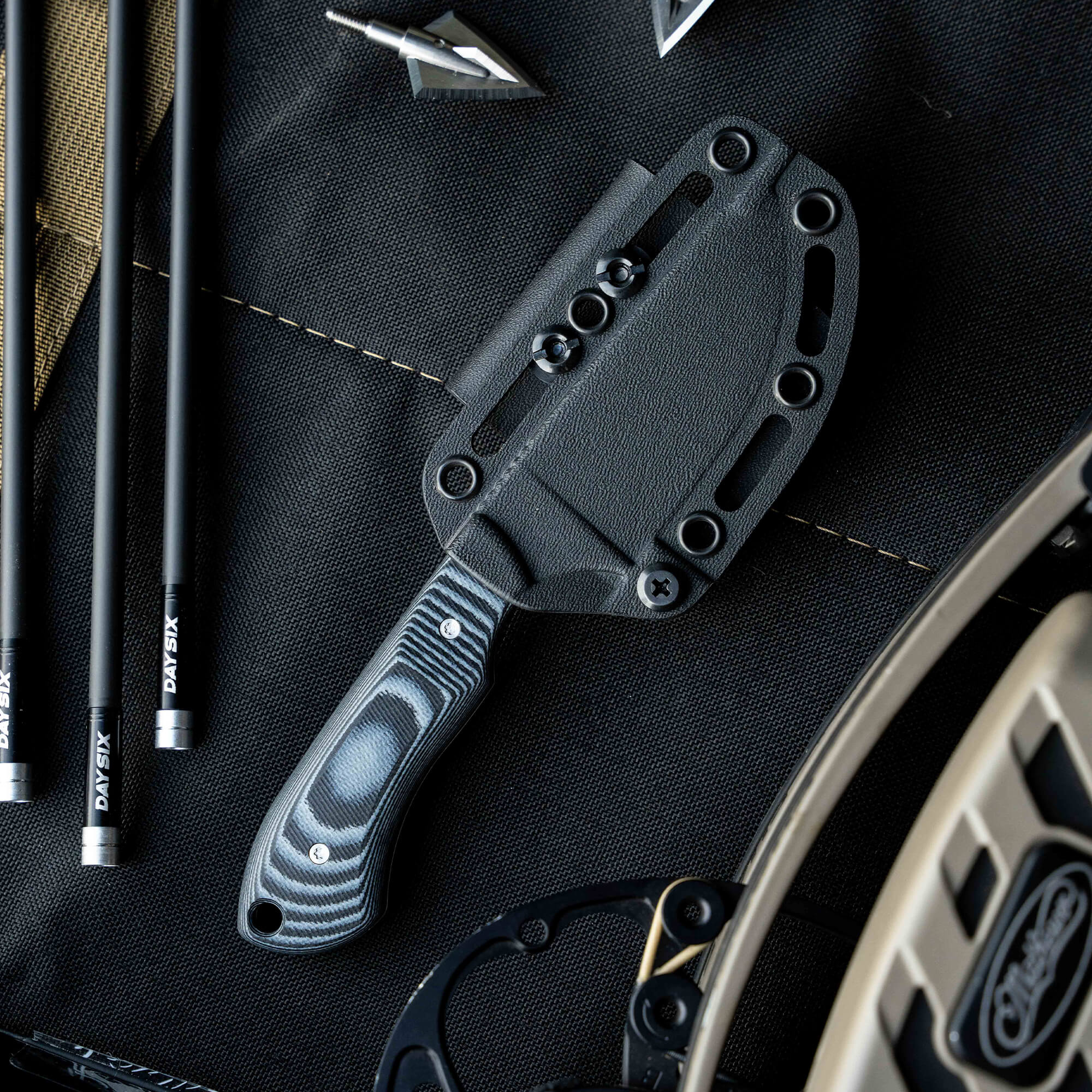 MKC Elk Knife with a textured handle and sheath, designed for outdoor enthusiasts and hunters.