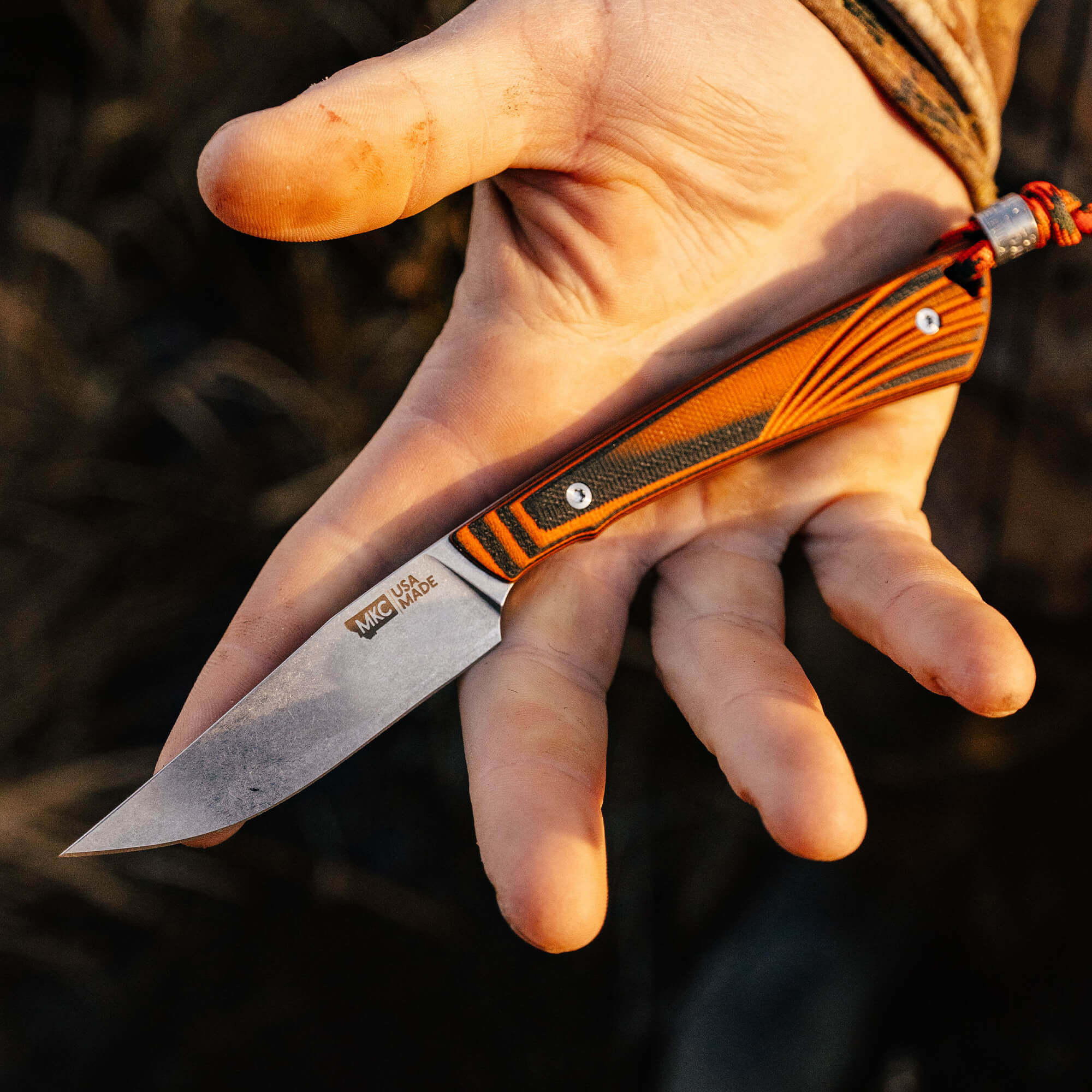 Montana Knife Company's CHÊNE Freezout knife features a sleek blade and vibrant handle, designed for outdoor enthusiasts.