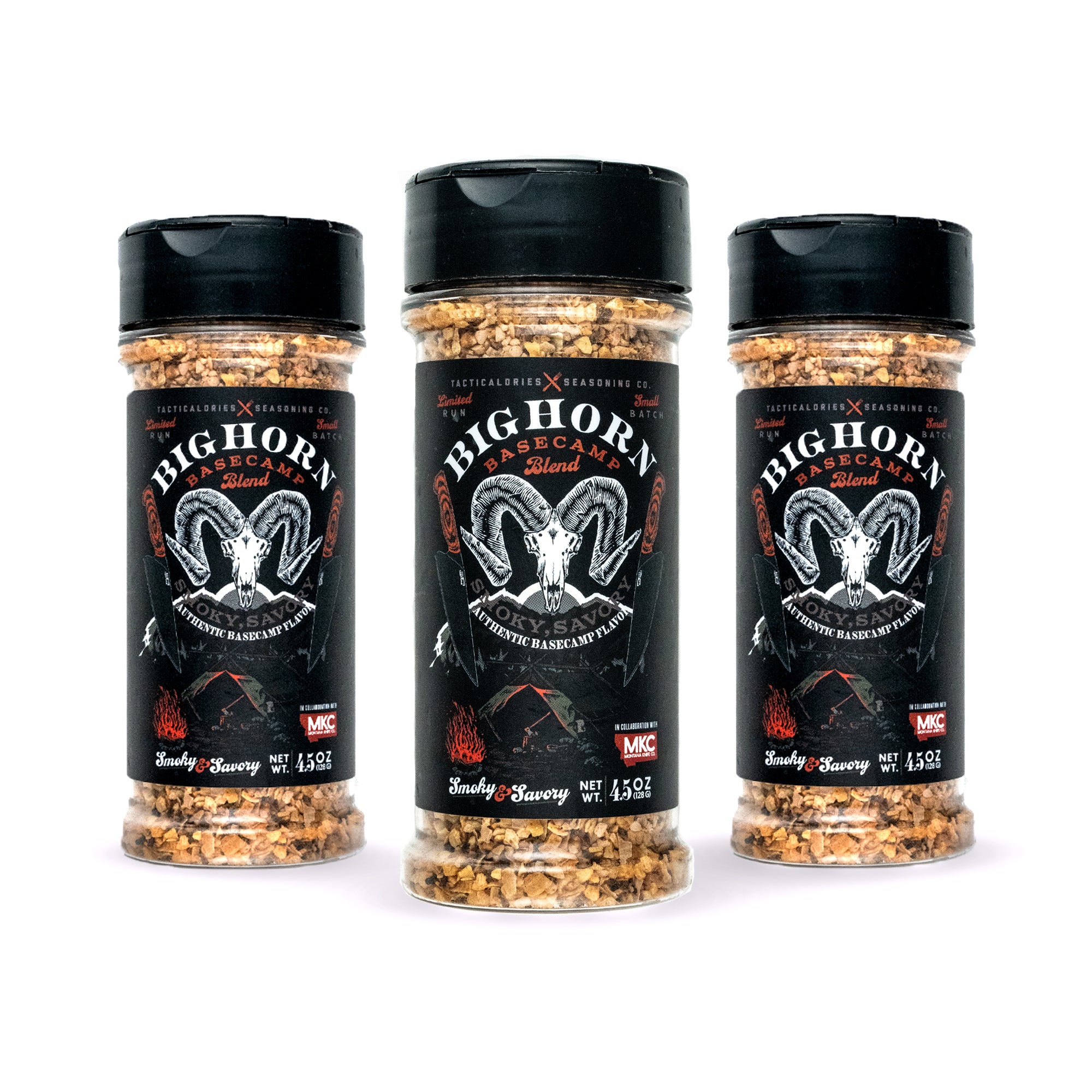 Three containers of BIGHORN BASECAMP SEASONING with a prominent black and red label featuring a skull and crossbones graphic, promoting the 'Smoky & Savory' blend. Each clear container displaying visible spices and herbs.